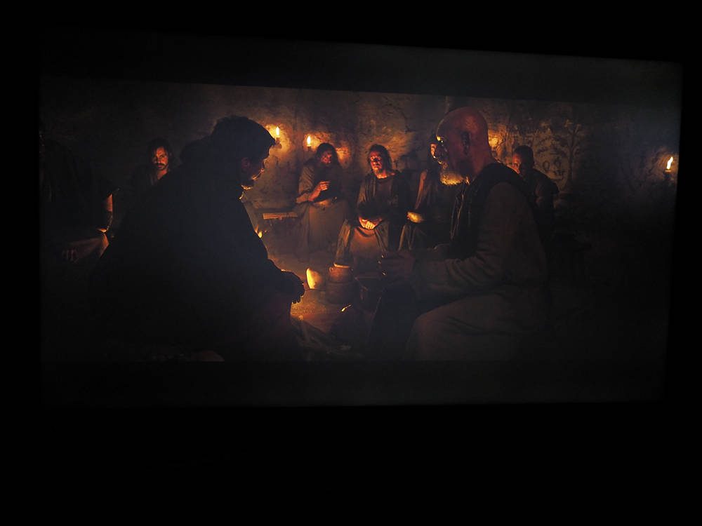 grupa mężczyzn rozmawia przy ognisku